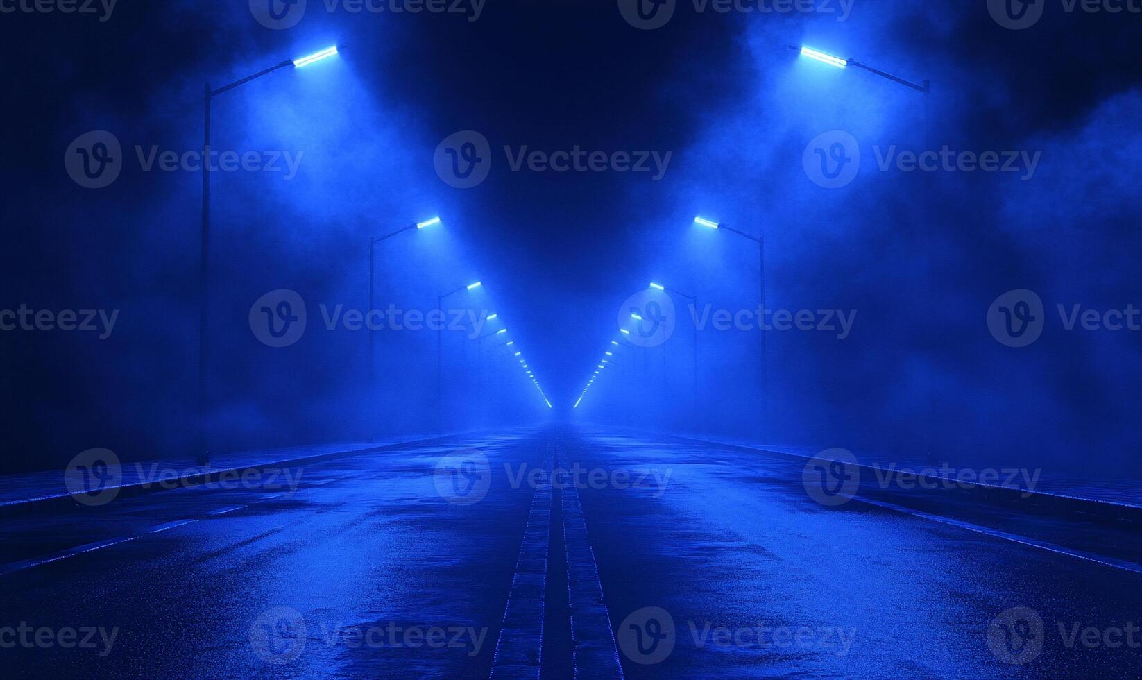 A misty road illuminated by blue streetlights at night. photo
