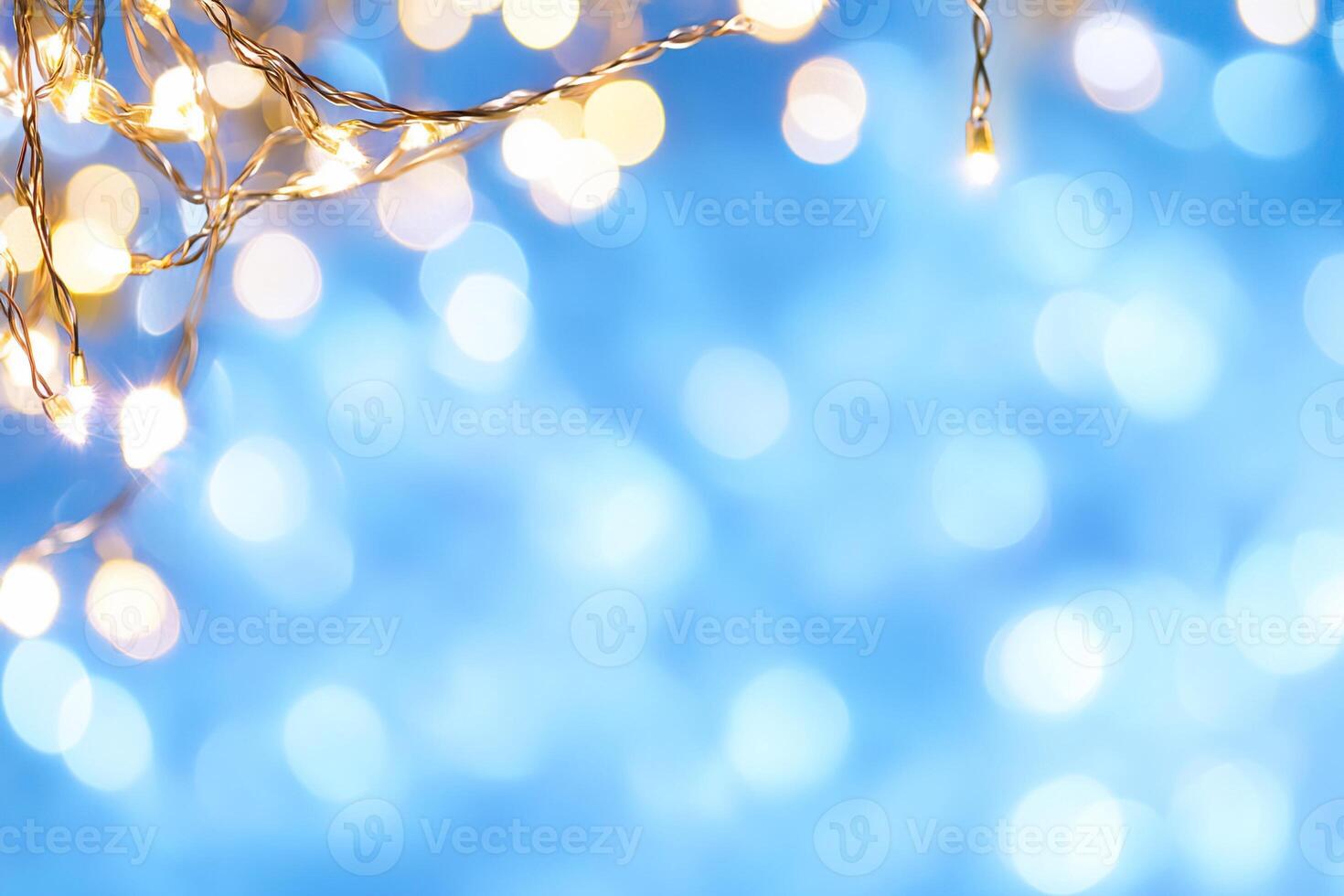 A soft-focus background of twinkling lights against a blue backdrop. photo