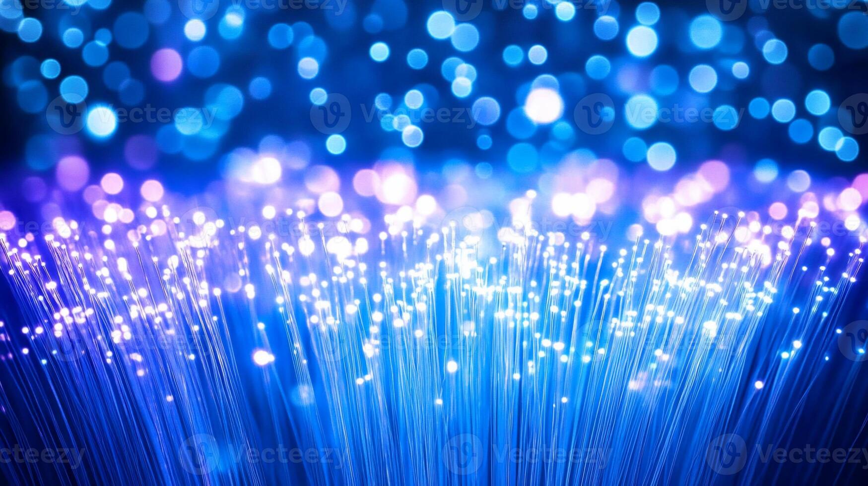 A vibrant display of glowing fiber optic strands against a blue backdrop. photo
