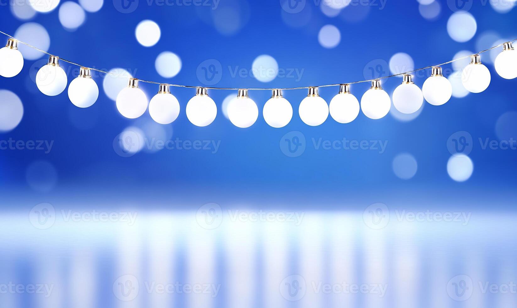 A string of glowing white lights against a soft blue background. photo
