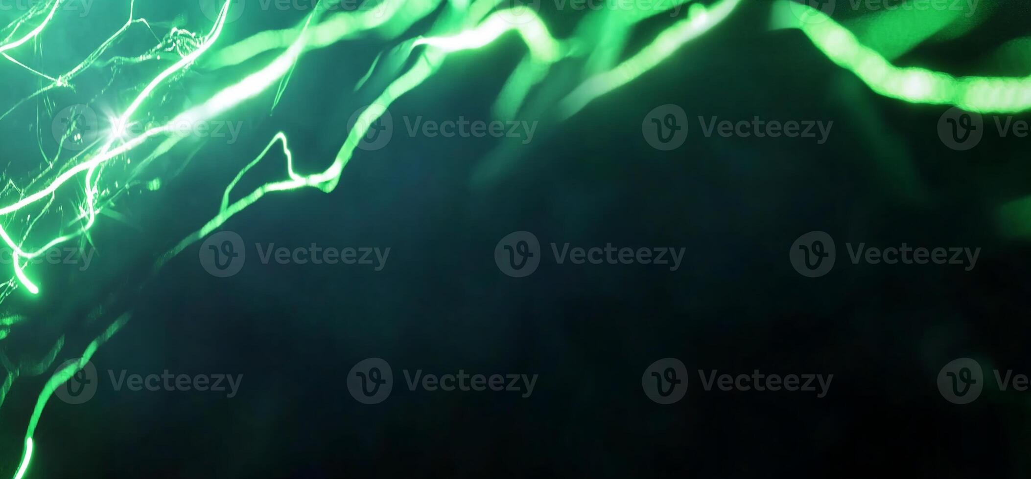 Abstract image featuring green light streaks against a dark background. photo