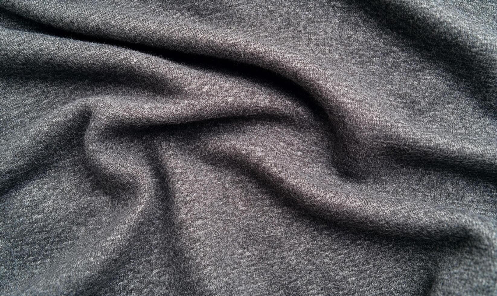 A close-up view of soft, textured gray fabric draped elegantly. photo
