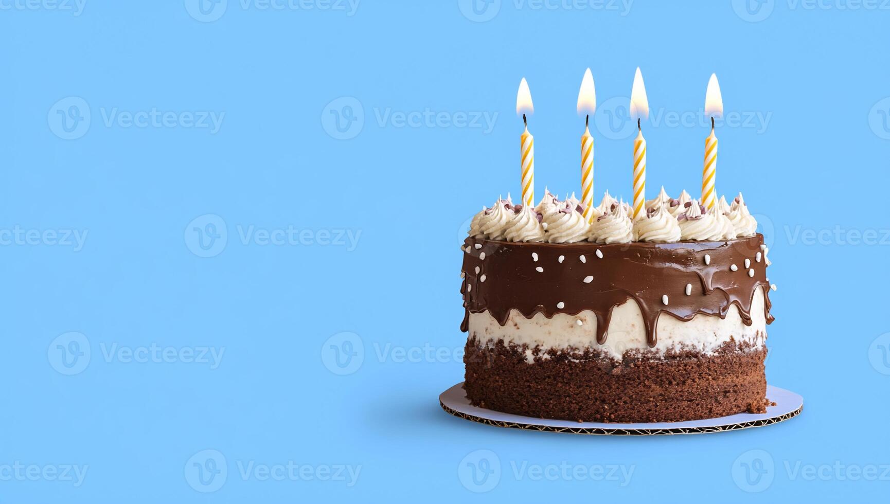 A chocolate birthday cake with candles on a blue background. photo