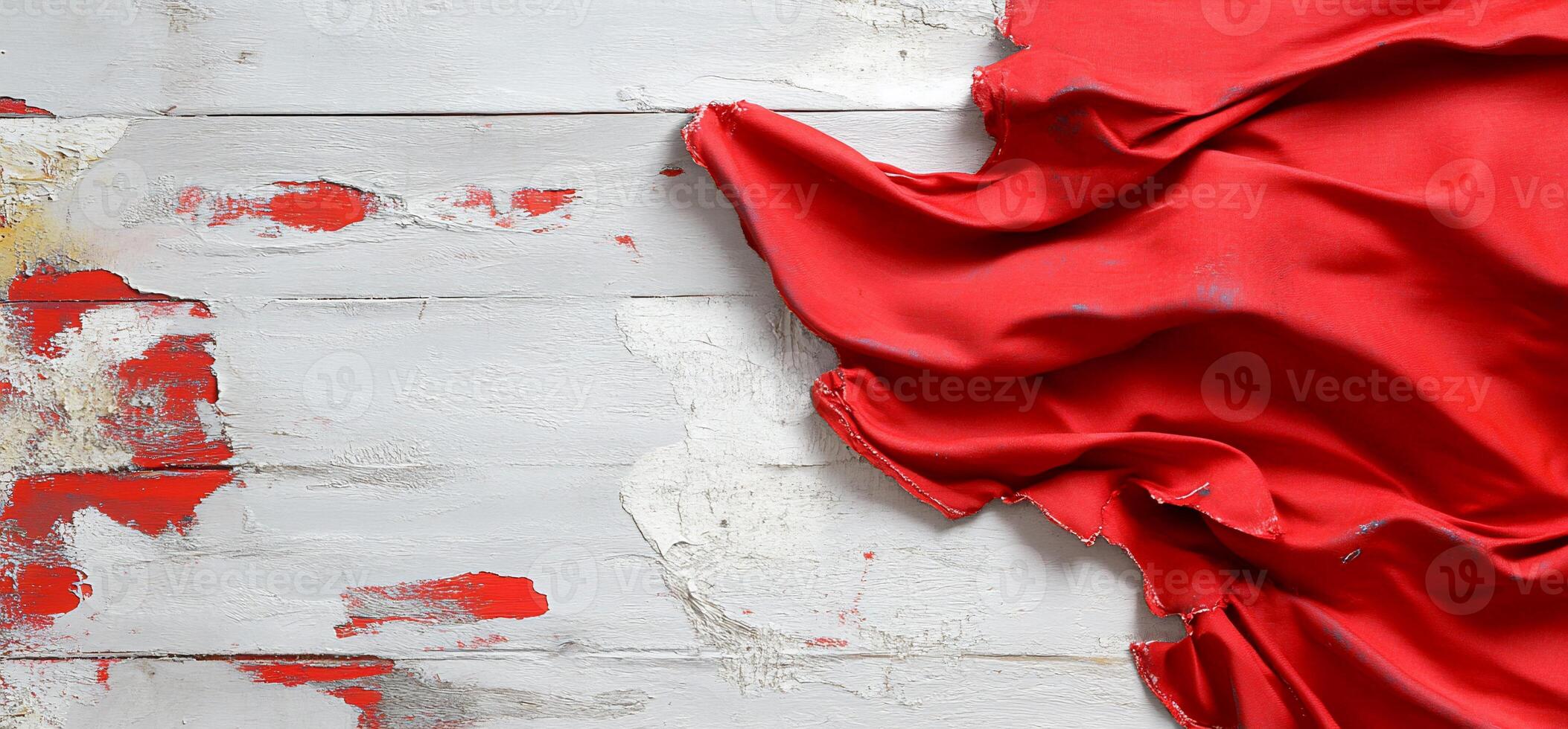 A vibrant red fabric draped over weathered wooden boards. photo