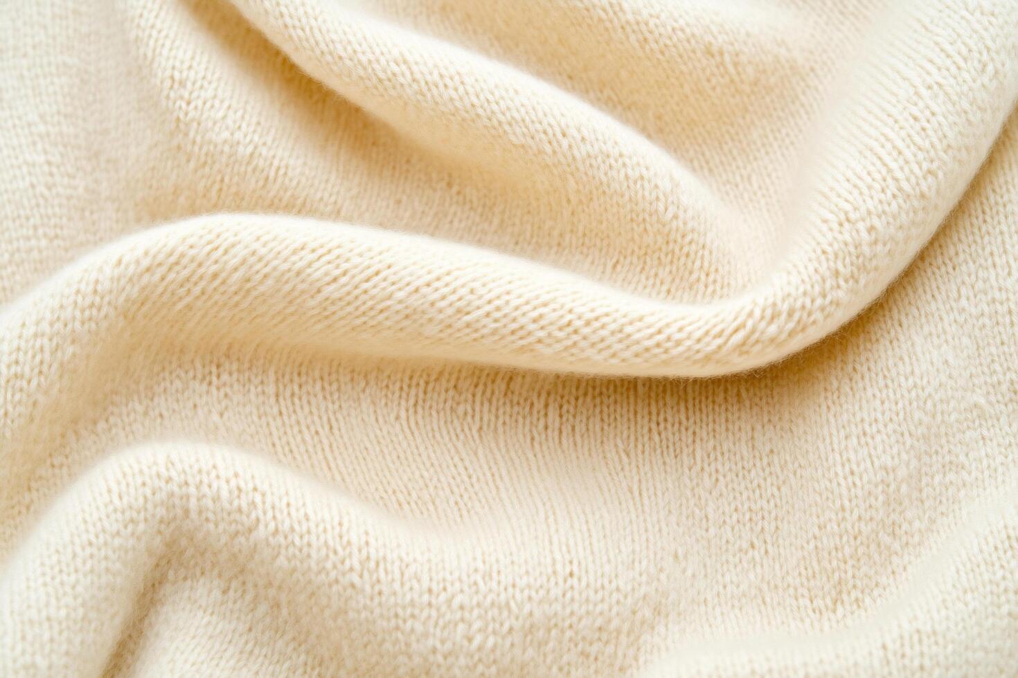 Soft, cream-colored fabric draped elegantly, showcasing texture and warmth. photo