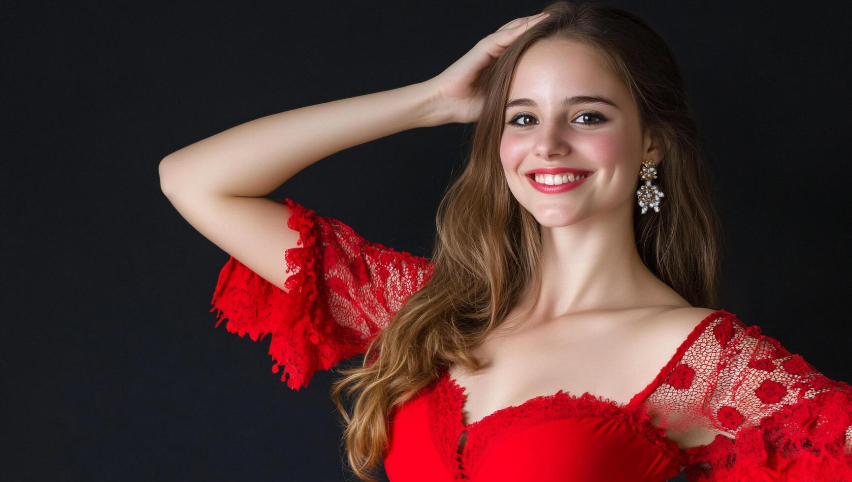 A smiling woman in a red dress poses against a dark background. photo