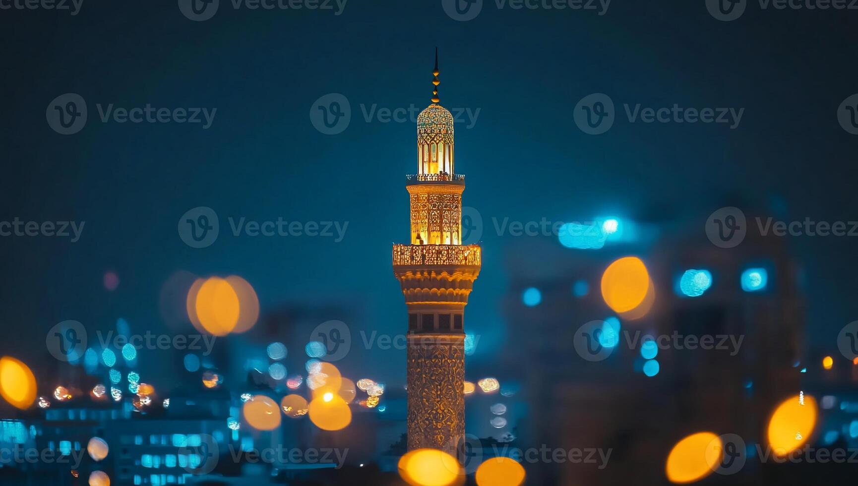 A beautifully lit minaret at night, showcasing intricate architecture. photo