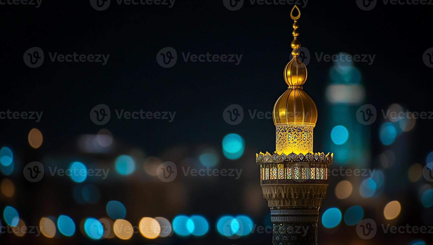 Night view of a mosque's golden dome and minaret illuminated. photo