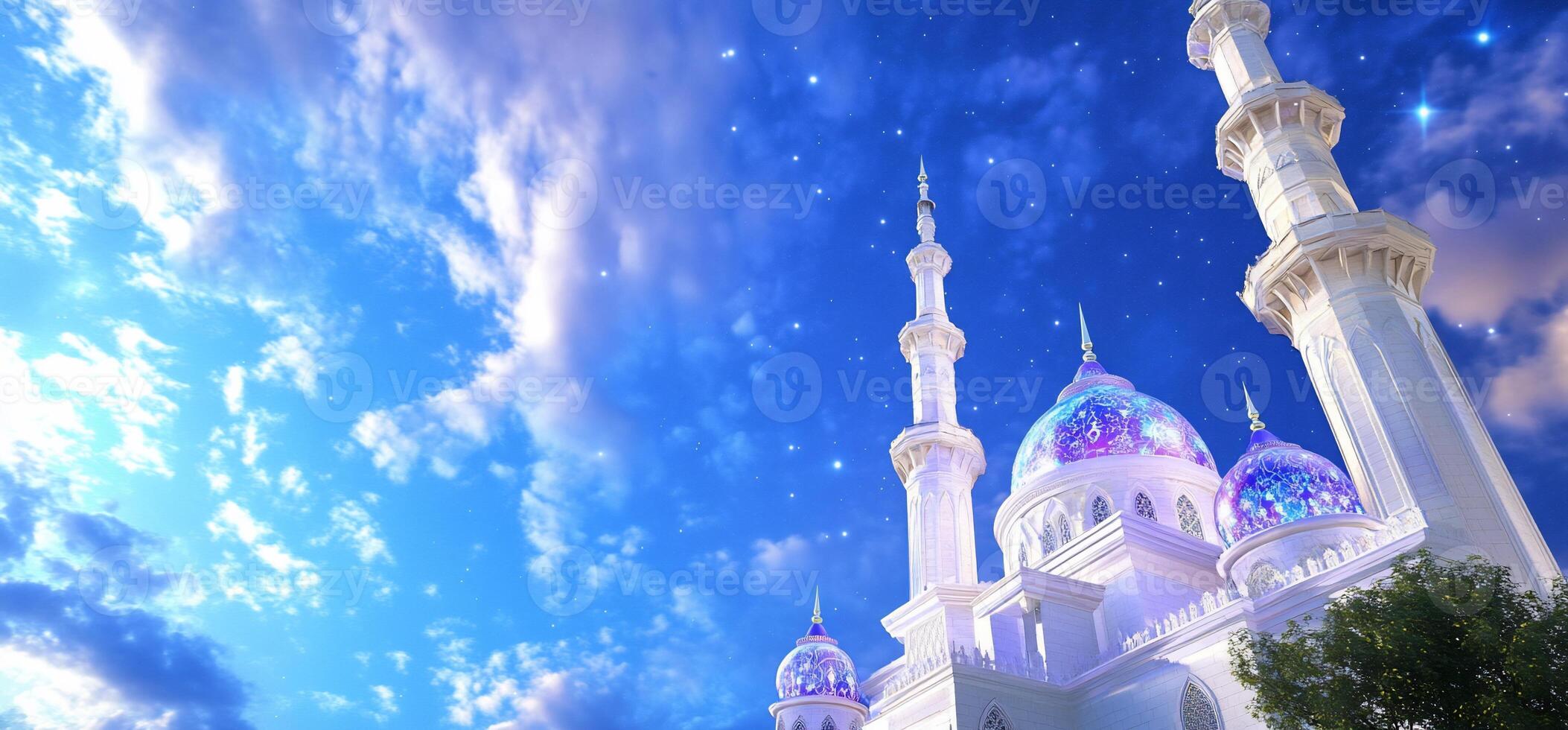 A beautiful white mosque with blue and purple towers photo