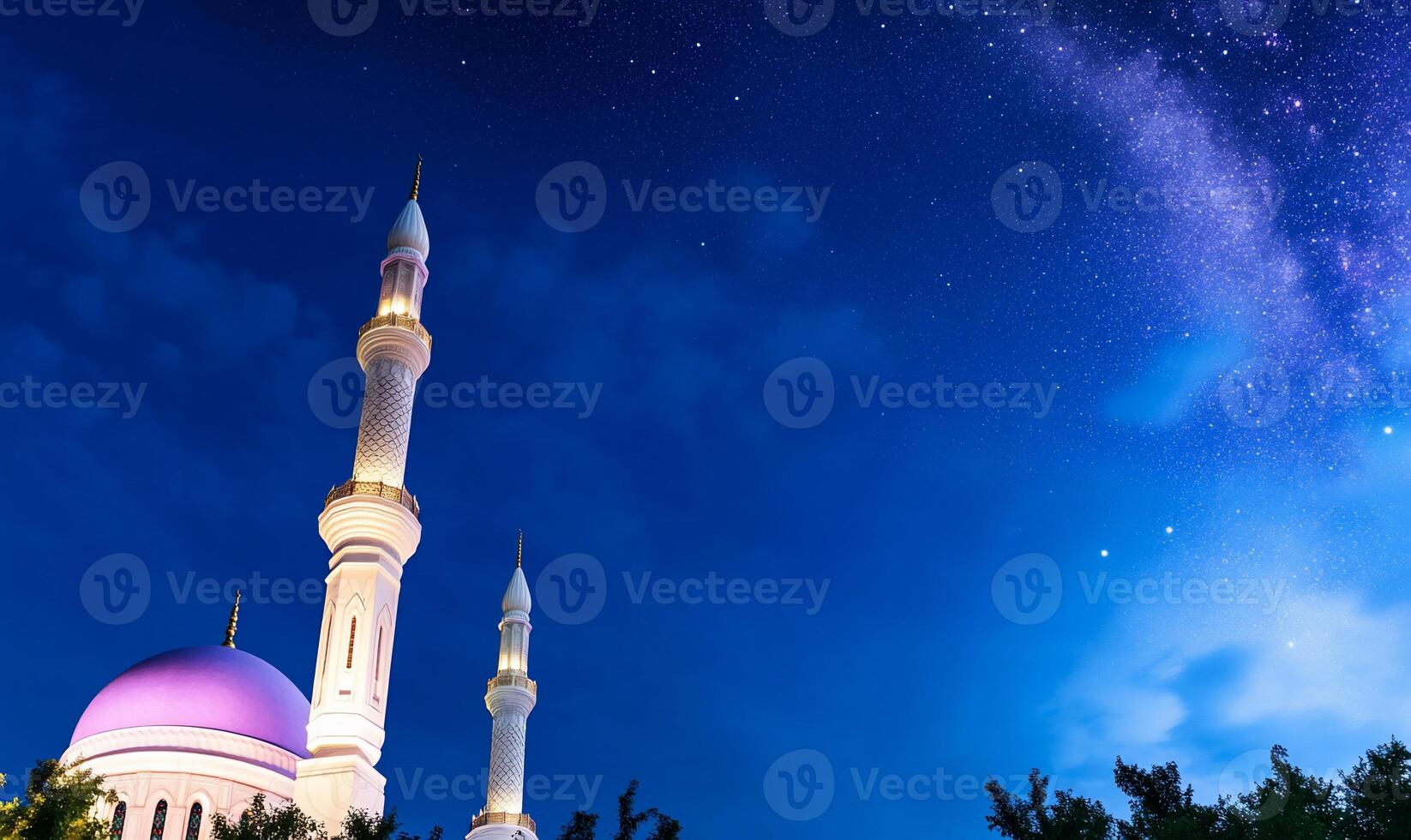 A mosque with minarets under a starry night sky. photo