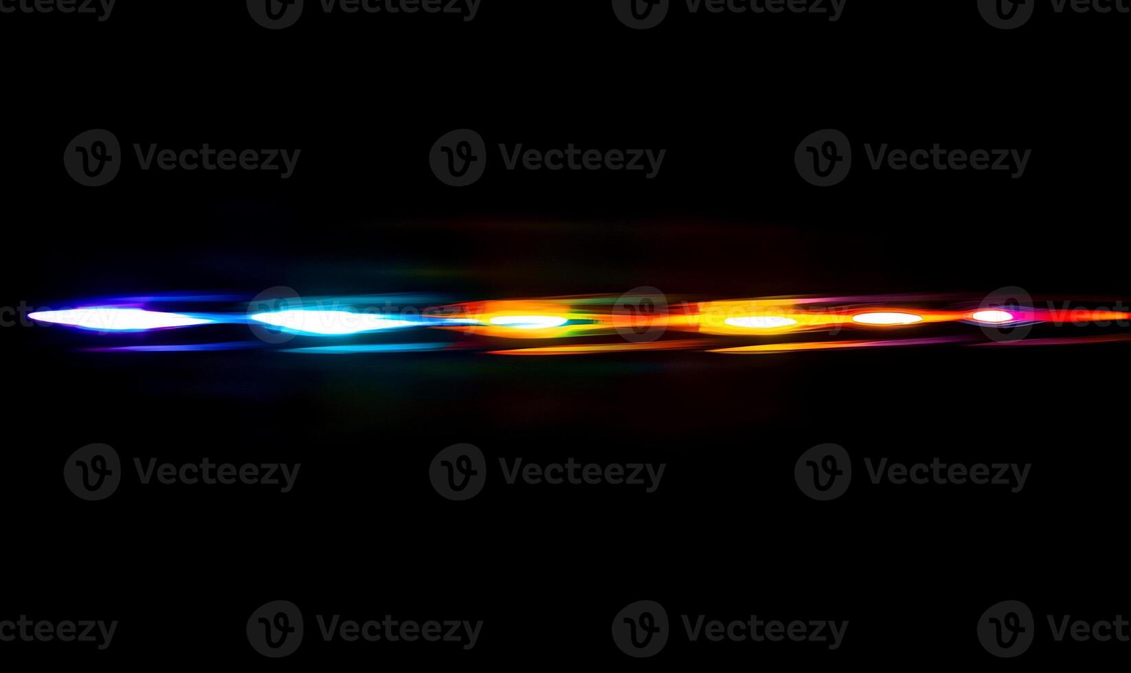 A colorful light streak against a dark background, suggesting motion. photo