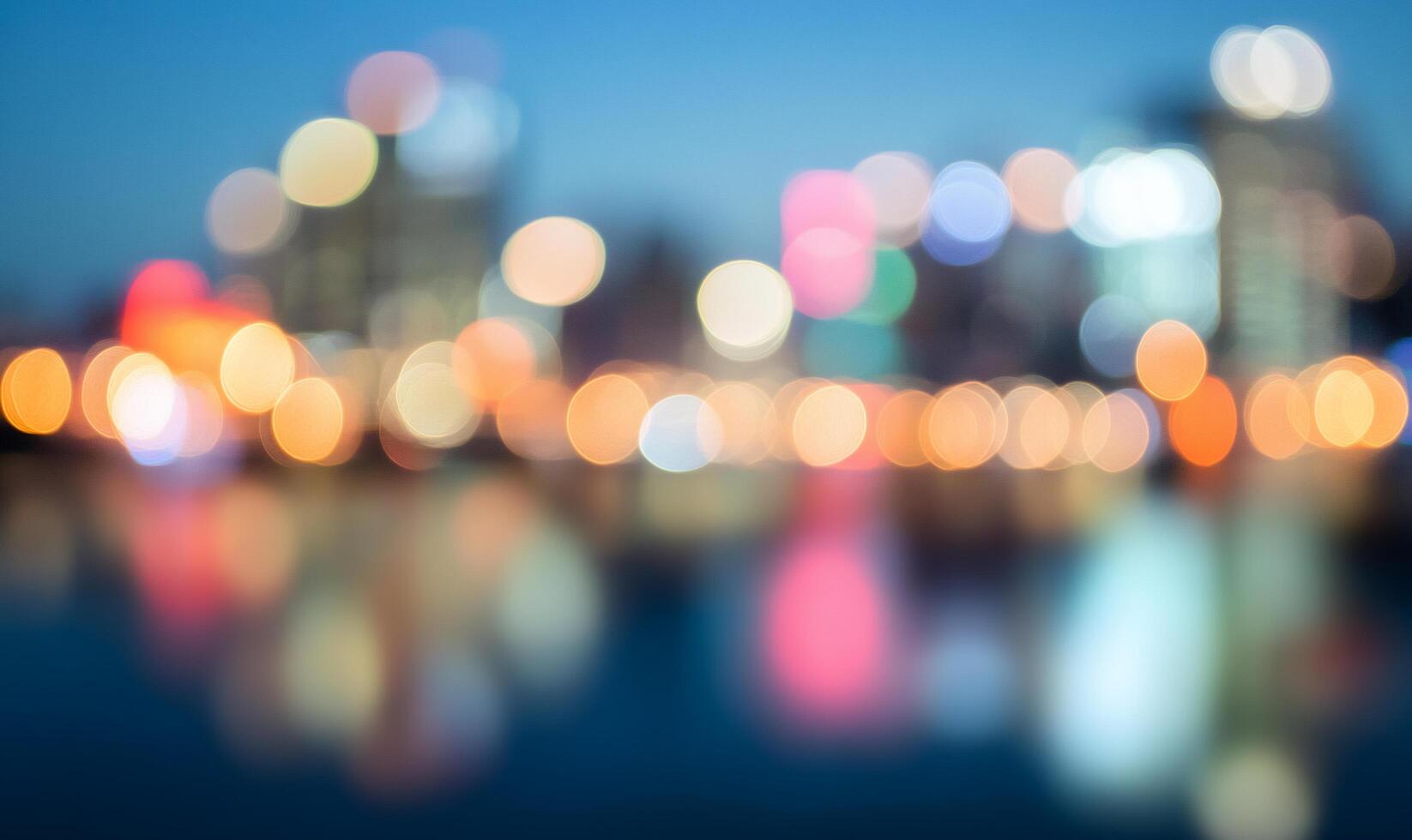 A blurred cityscape with vibrant lights reflecting on water. photo
