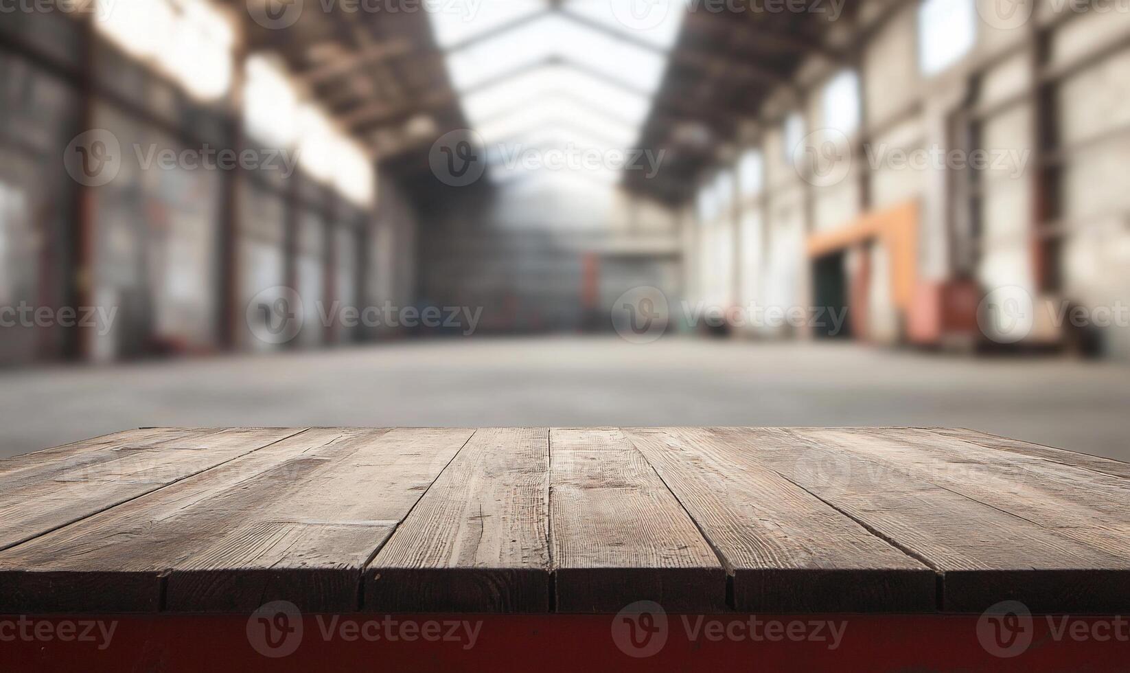 An empty wooden table in an industrial warehouse photo