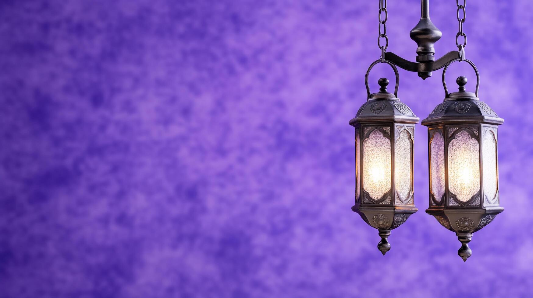 Two decorative lanterns hanging against a textured purple background. photo