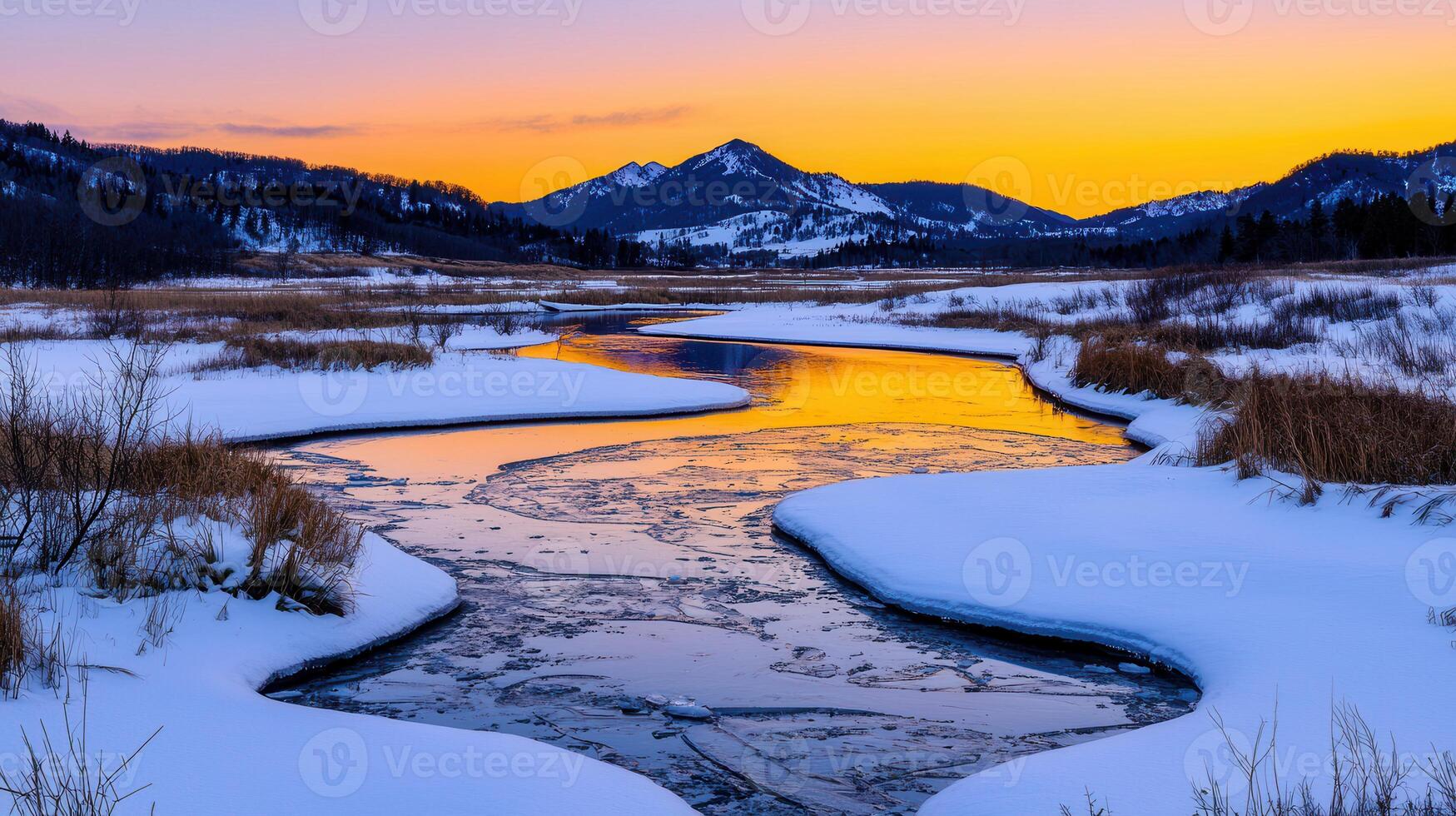 Serene Winter Sunset Frozen River Winding Through Snowy Landscape with Mountain Range photo