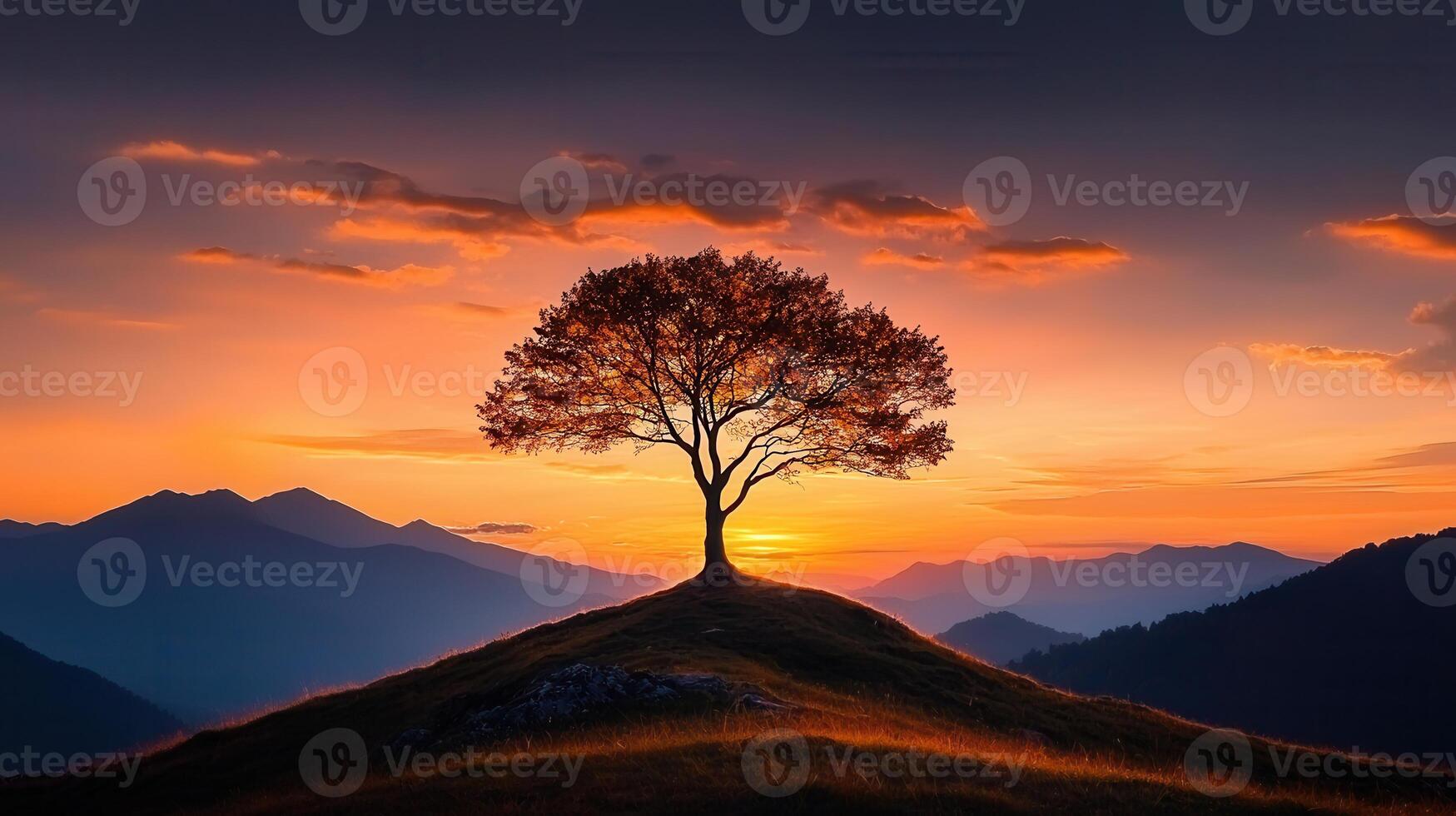 Majestic Sunset Landscape Solitary Tree on Hilltop with Mountain Range photo