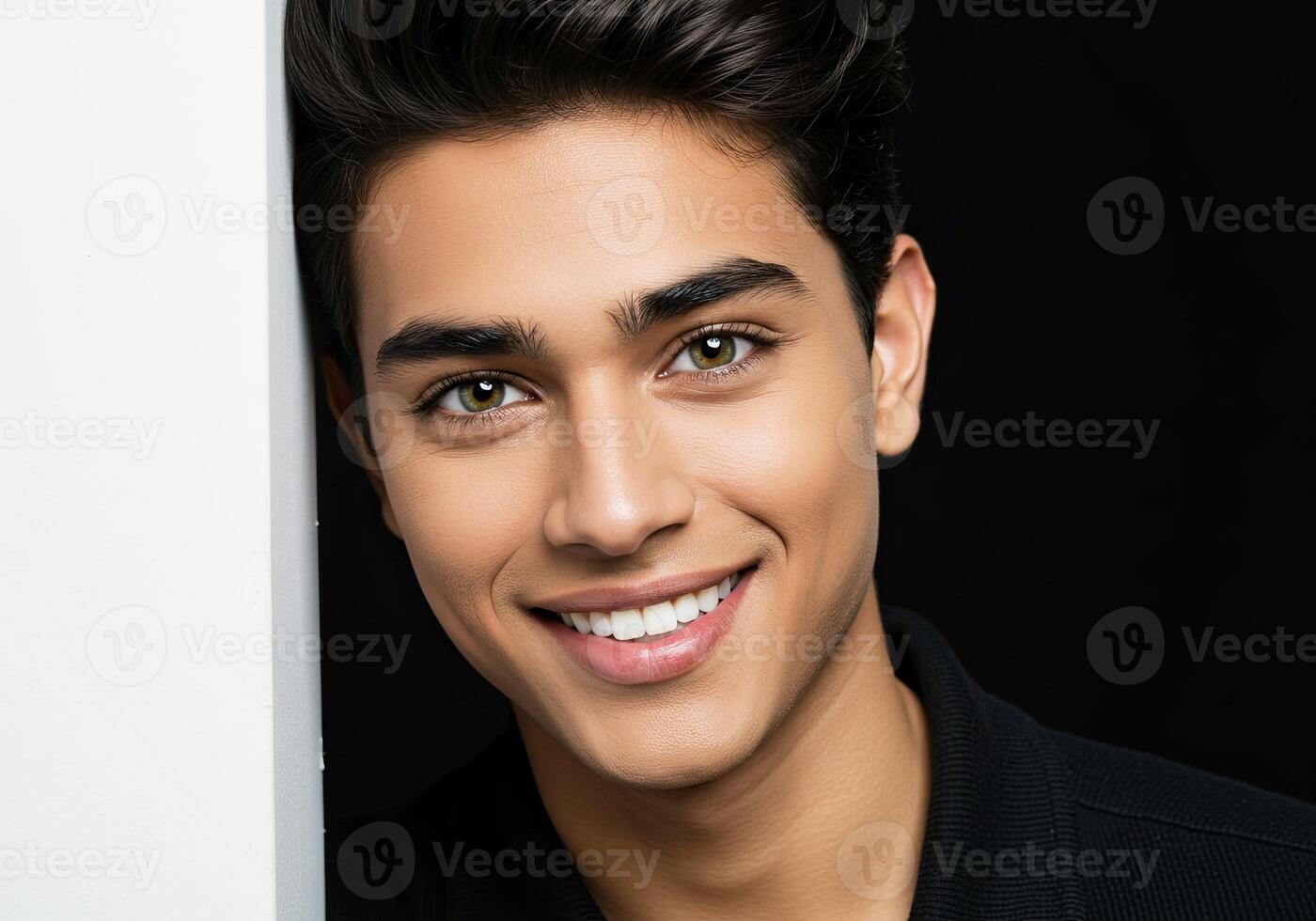 A young man with a black shirt and white teeth photo