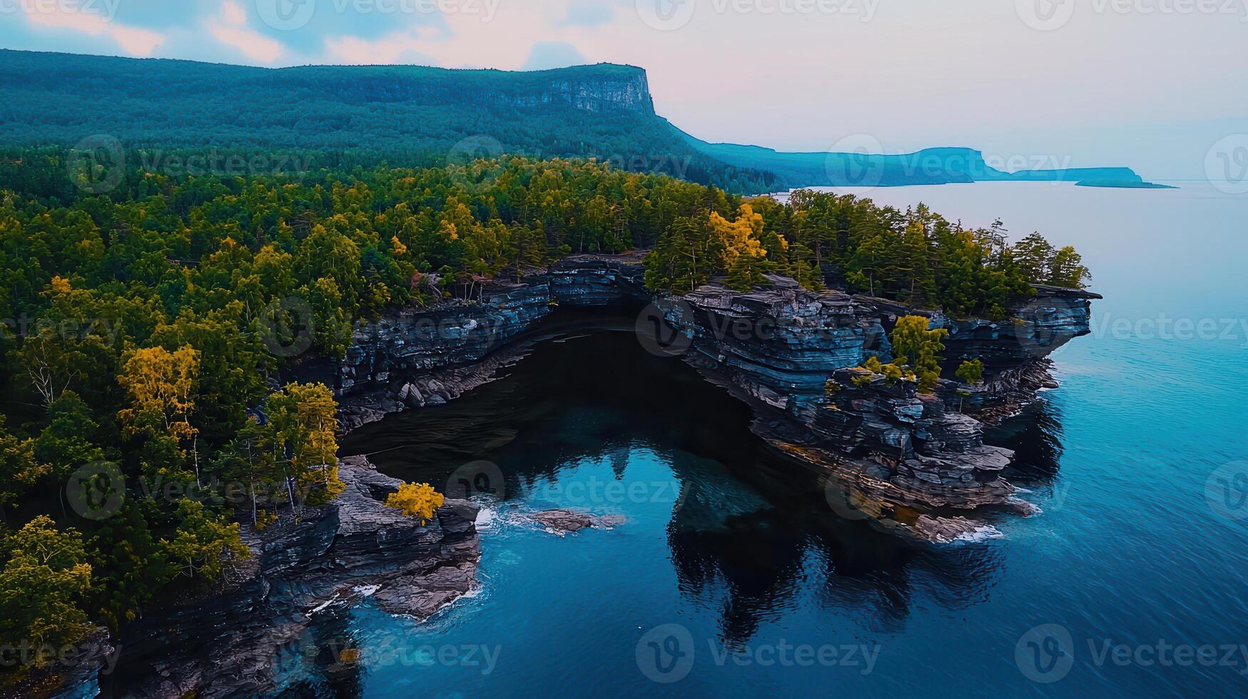 Stunning Aerial View of Dramatic Coastal Cliffs Azure Waters and Autumnal Forest photo
