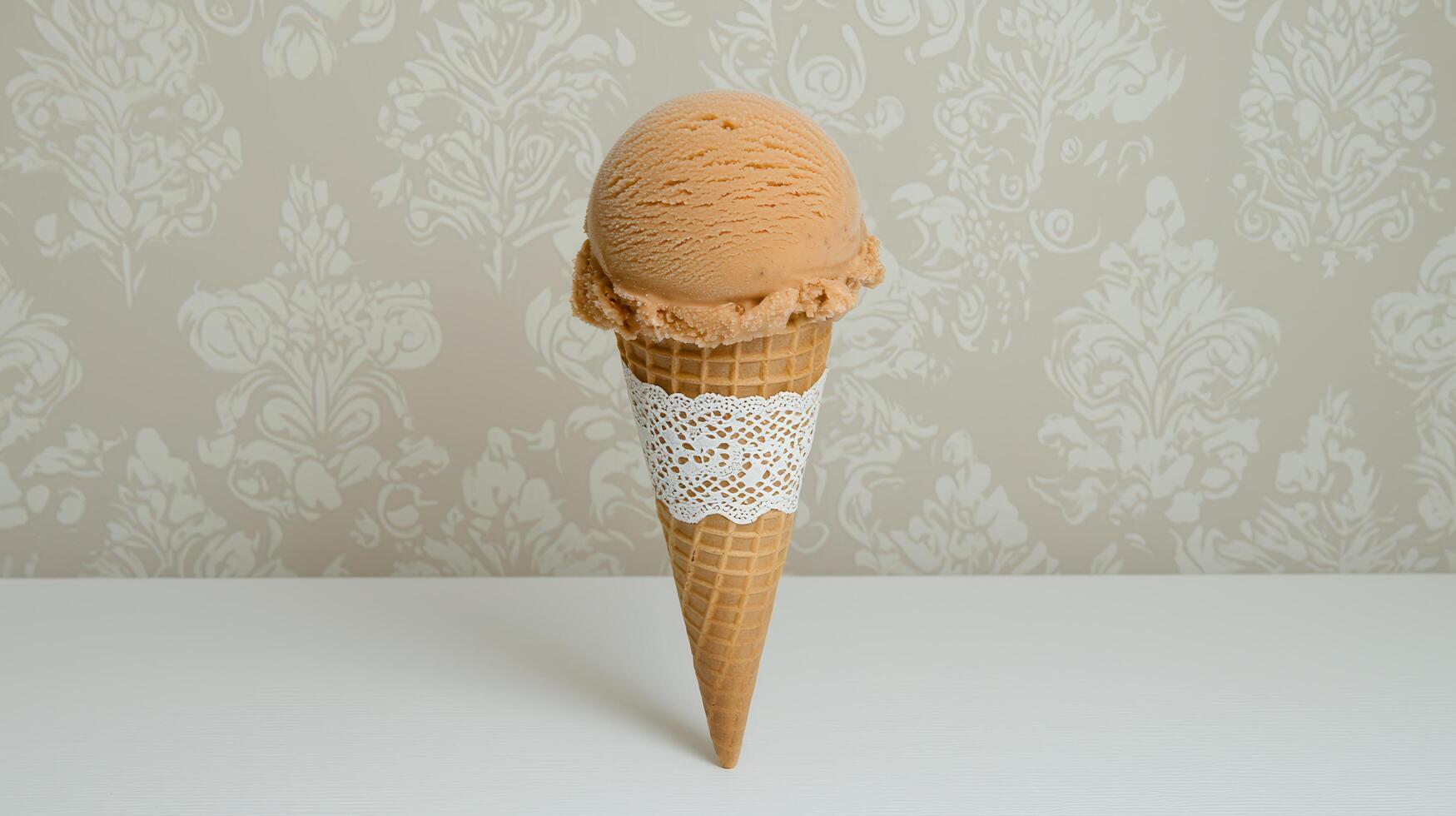 Delicious Caramel Ice Cream Scoop in Waffle Cone with Lace Elegant Dessert photo