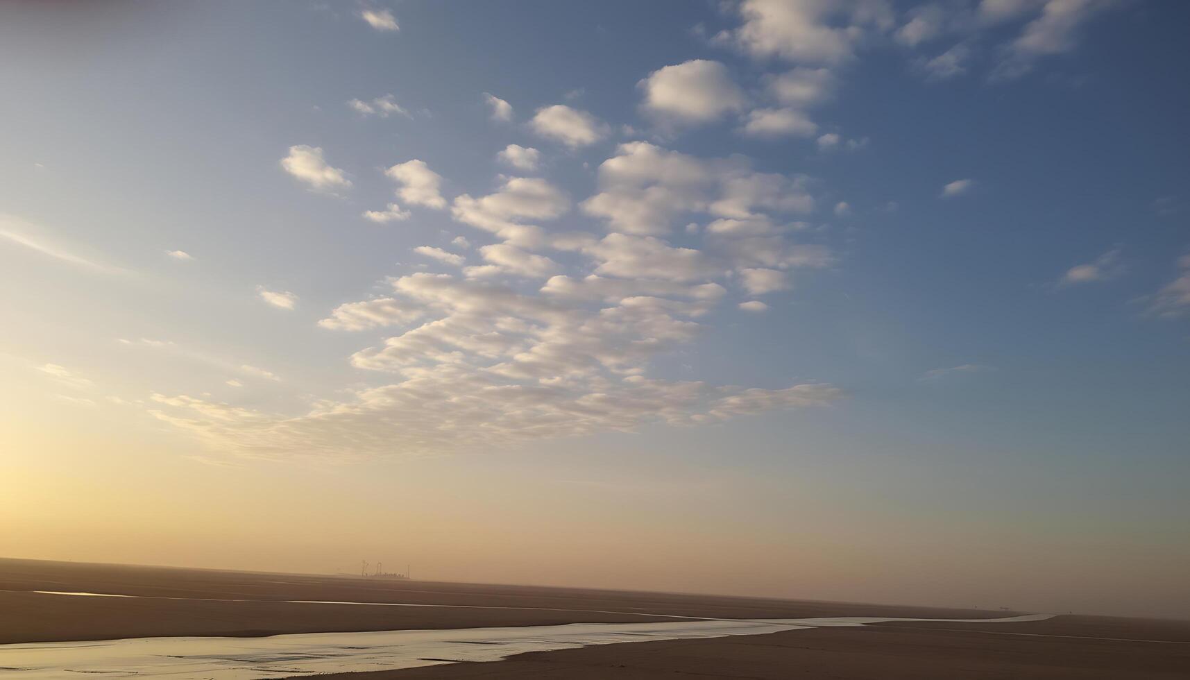 A river runs through a desert area with a sky above photo
