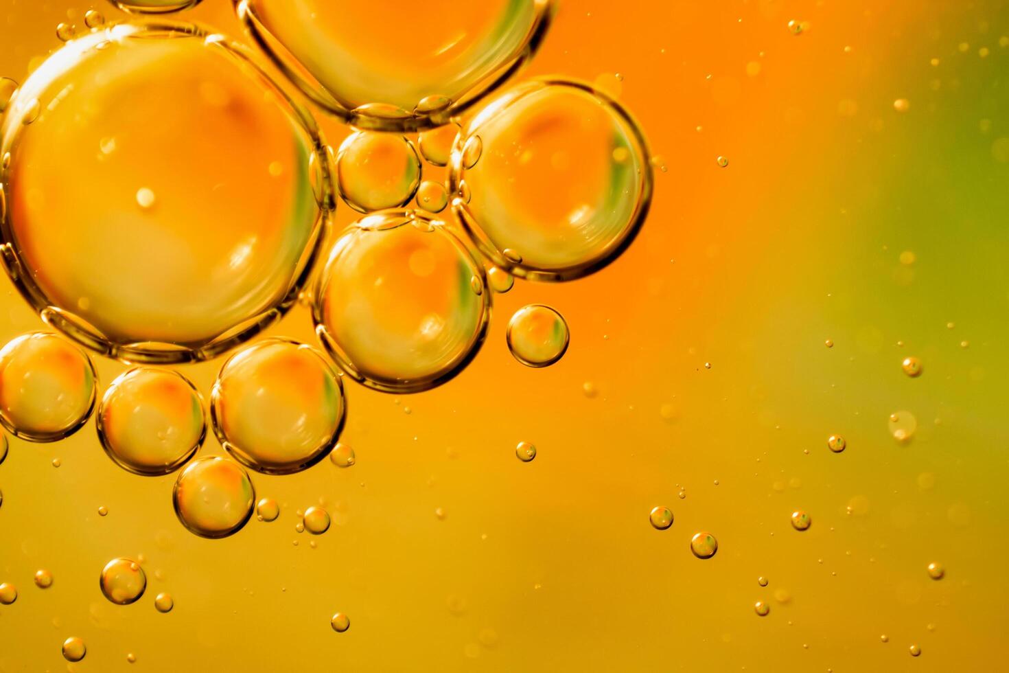 oil drops on water on an orange background photo