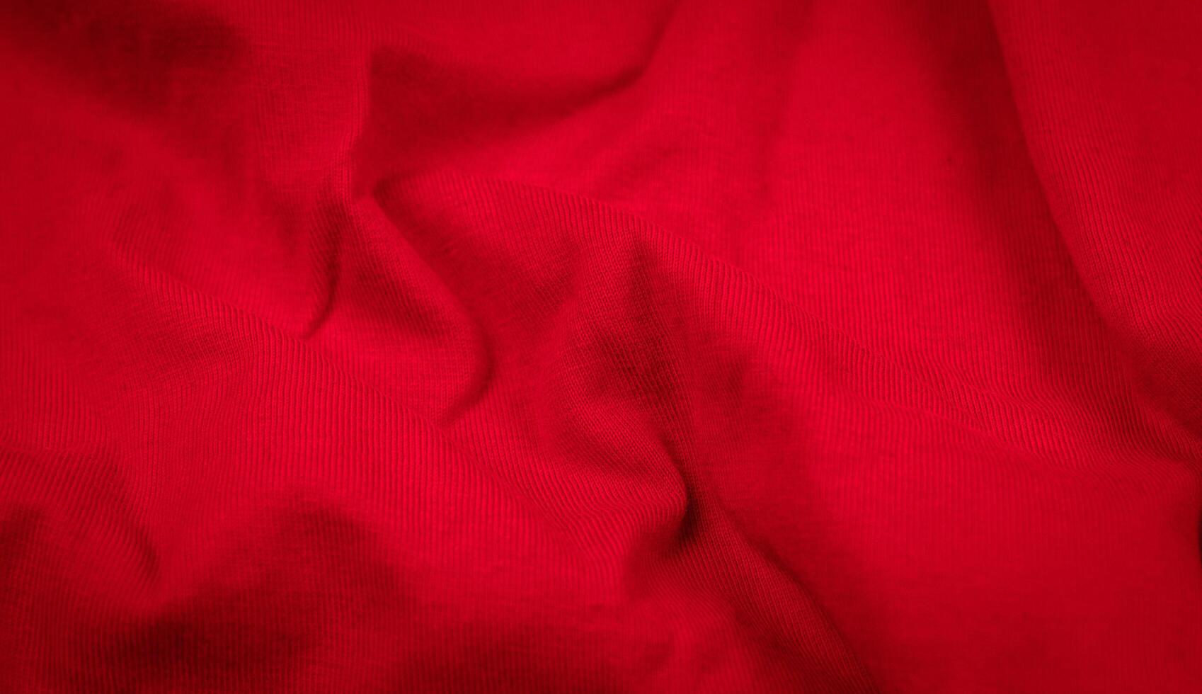 Red crinkled fabric with visible details. photo