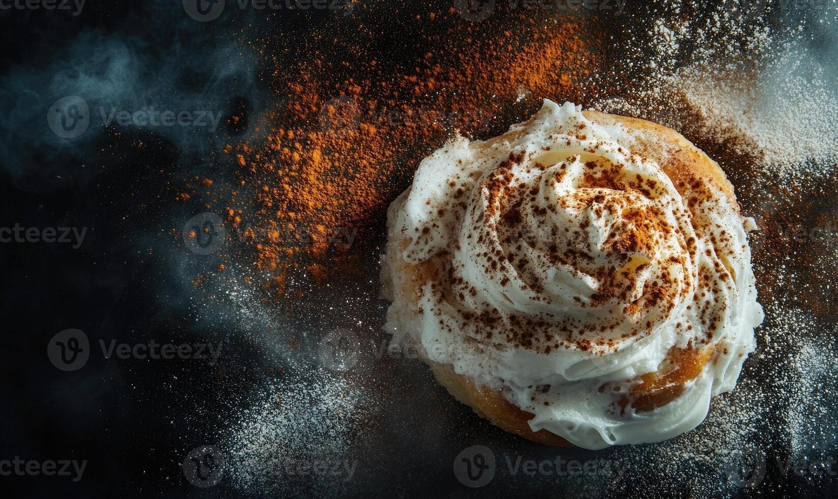 A cinnamon roll with a white frosting and brown sprinkles photo