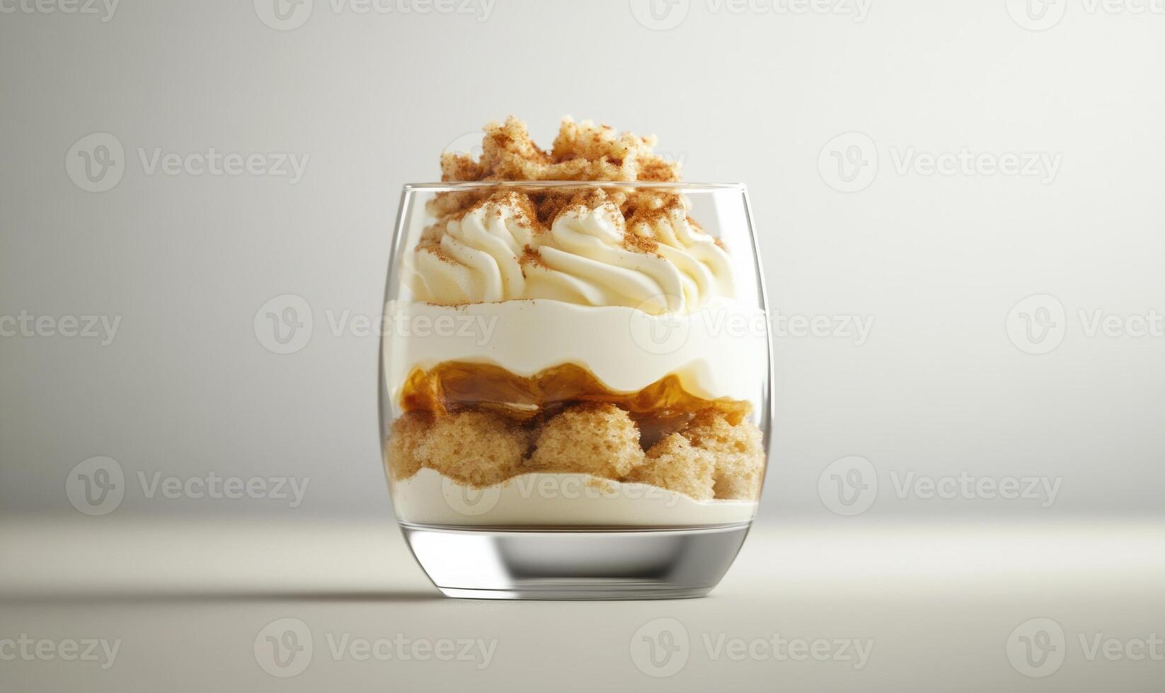 A glass of dessert with a layer of whipped cream on top photo