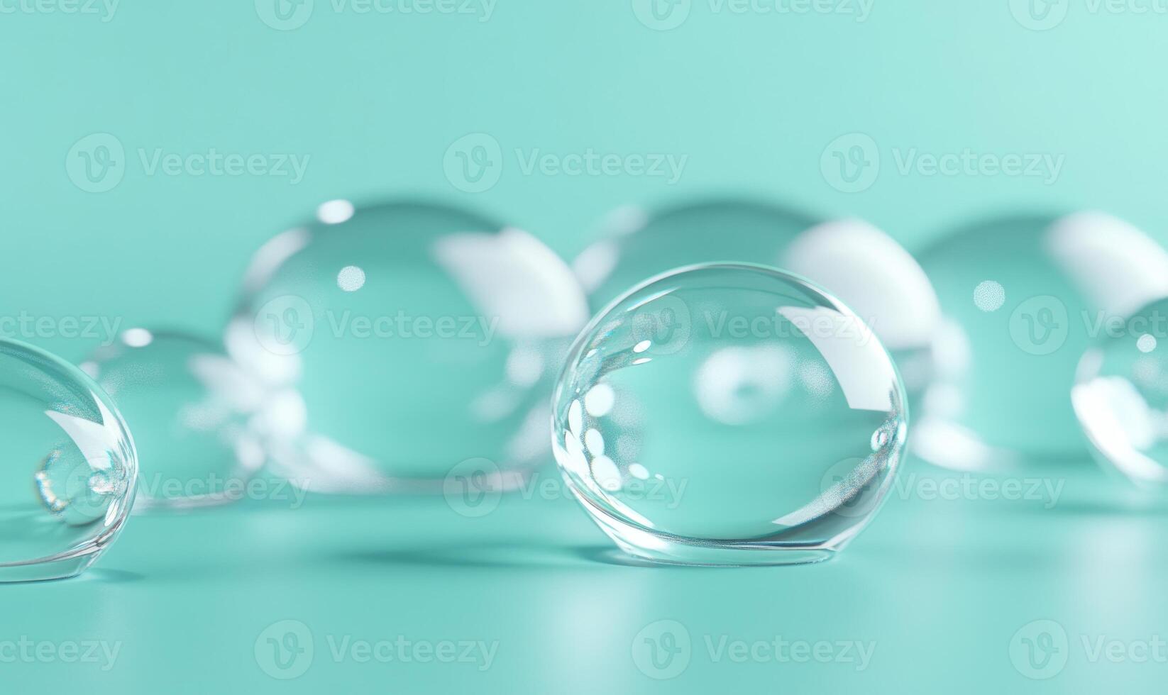 A group of clear glass spheres are sitting on a green surface photo
