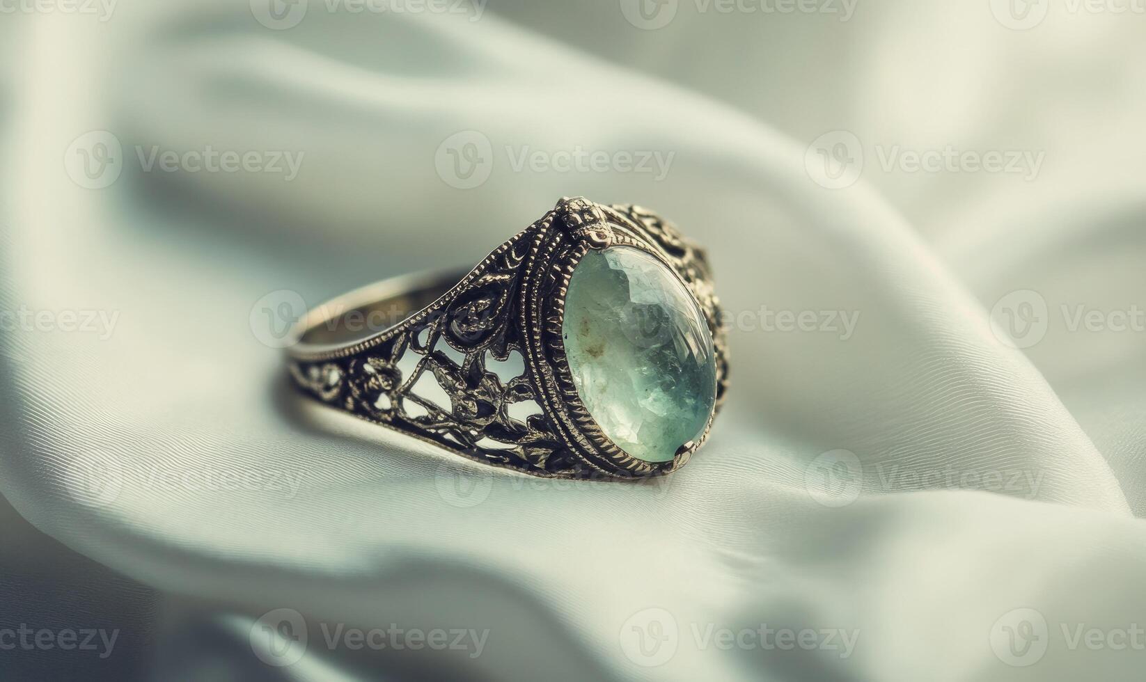 A ring with a green stone on it photo