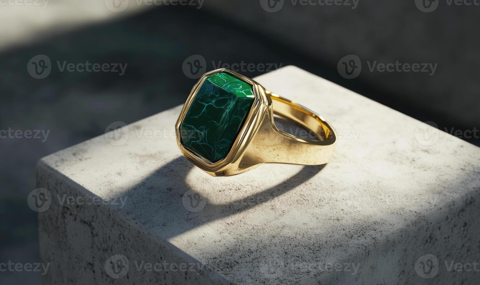 A gold ring with a green stone in the middle photo