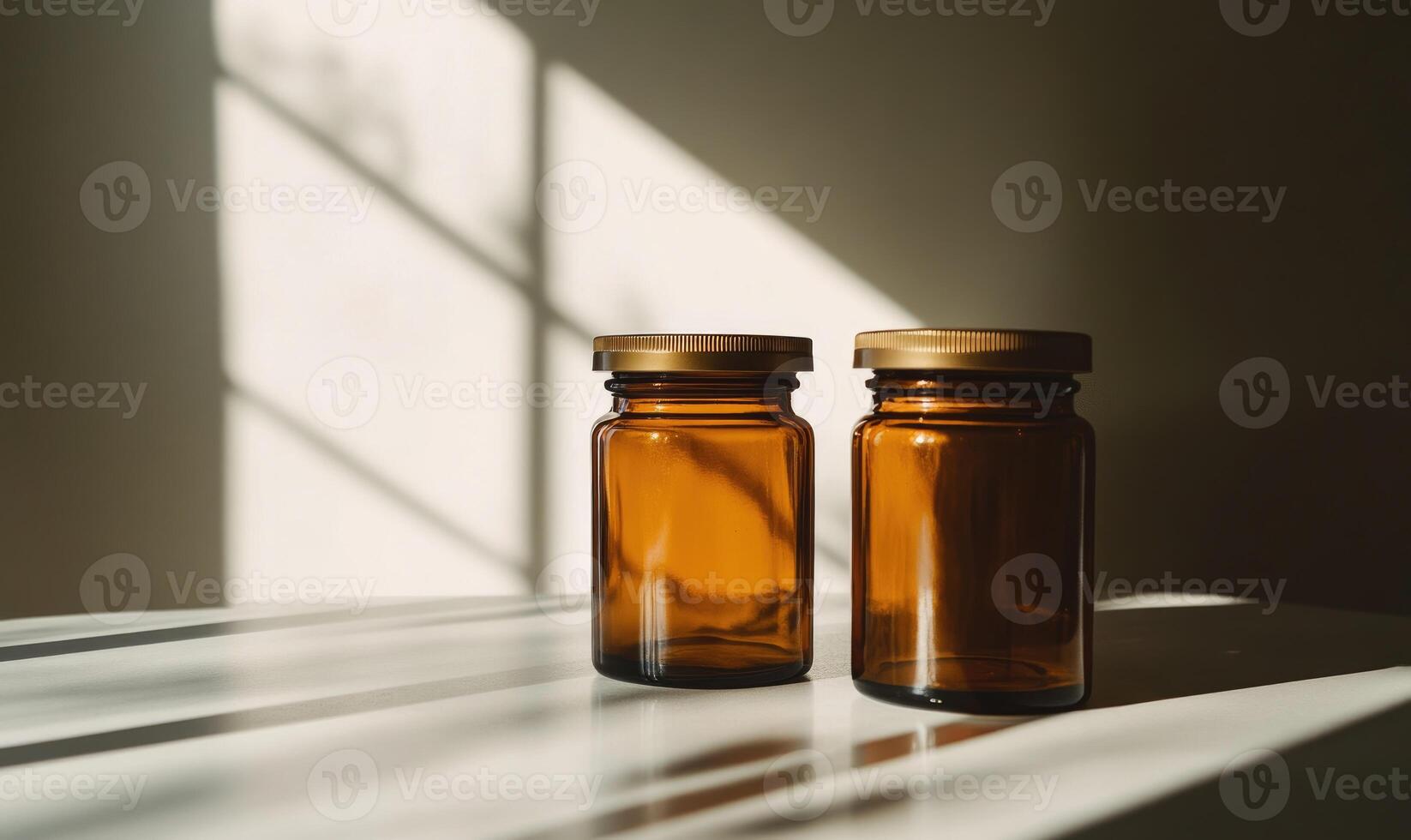 two glass bottles with brown lids sitting on a table photo