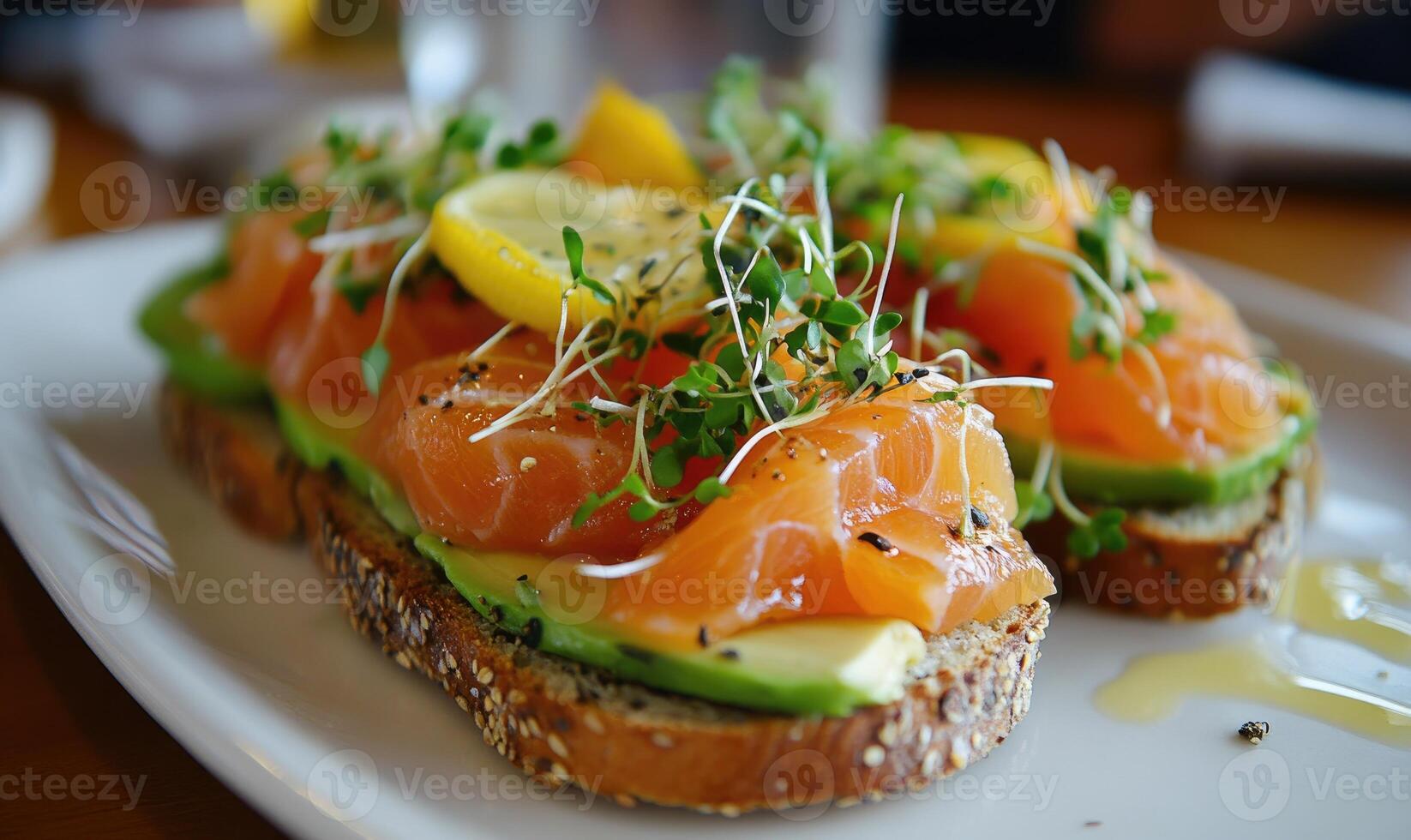 A plate of bread with avocado and salmon on top photo