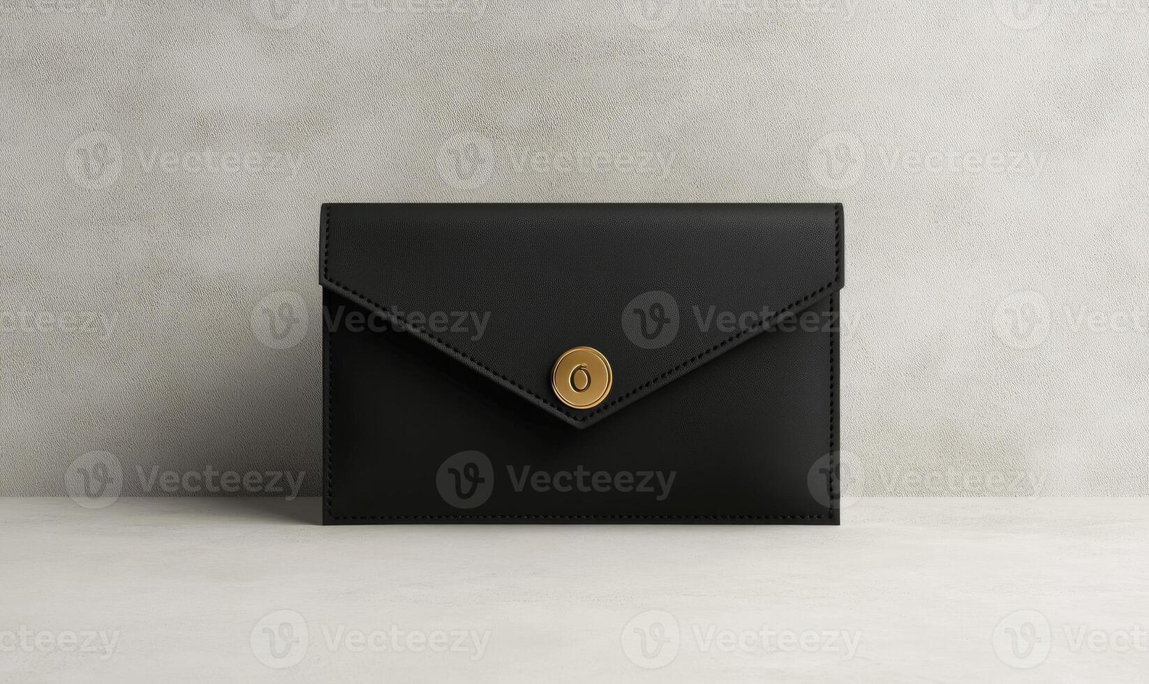 A black purse with a gold button on the front photo