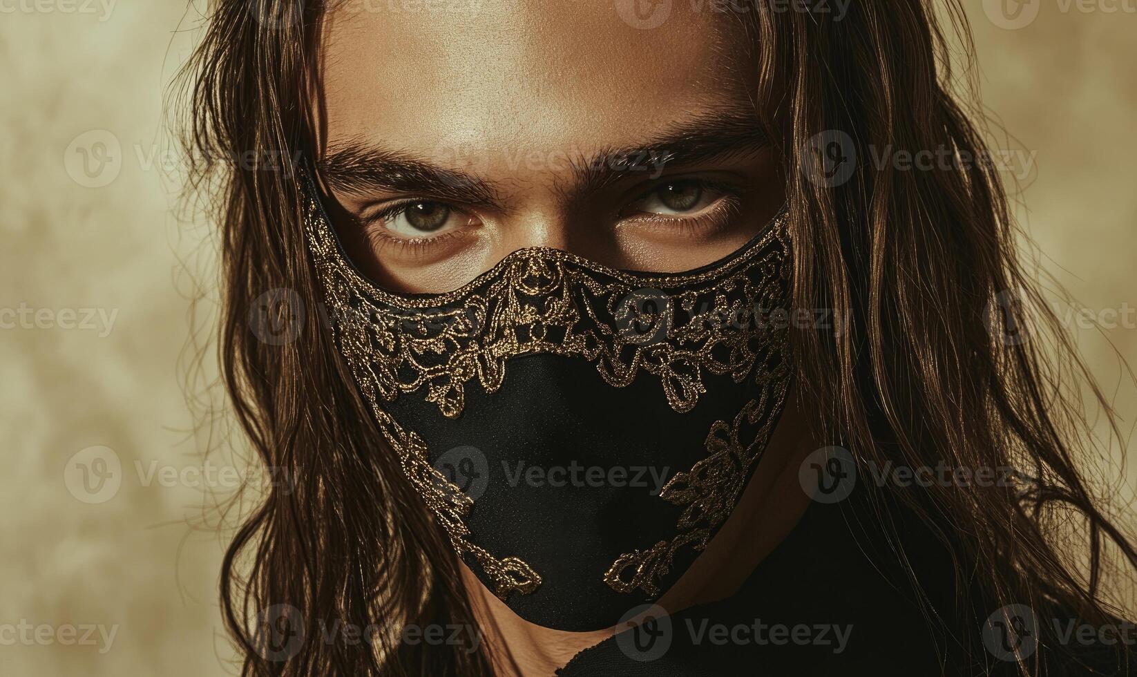 A man with long hair is wearing a mask with gold lace photo