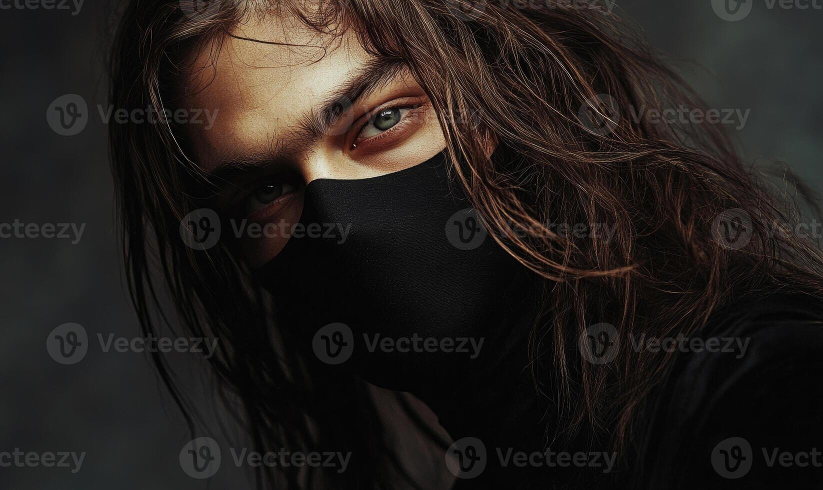 A man with long hair and a black mask on his face photo