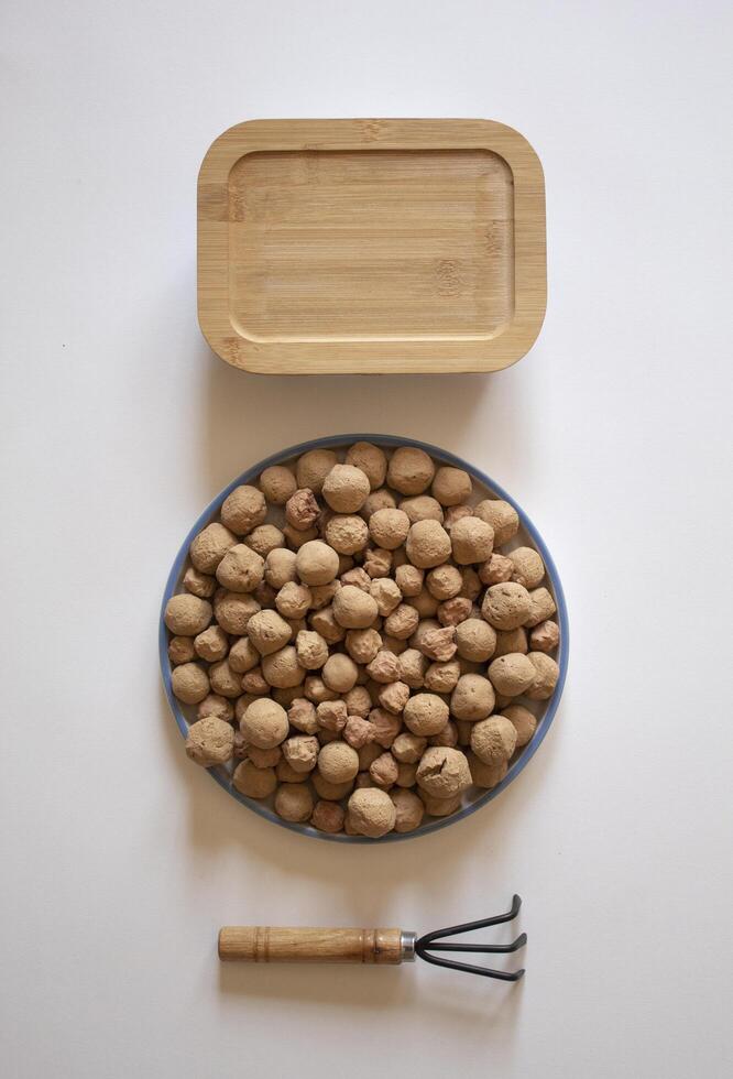 Edible caramel clay stones with a lunchbox and a wrack on a white background. photo