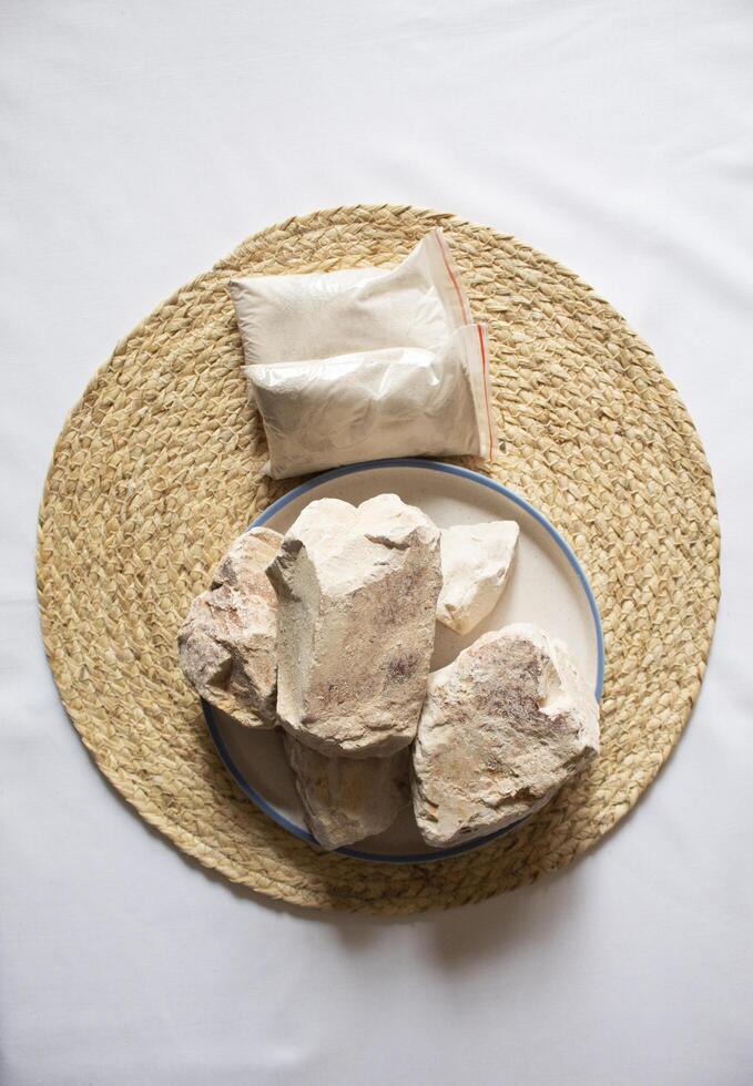 Edible White Clay Stones, with a small clay powder minimal flat lay photo
