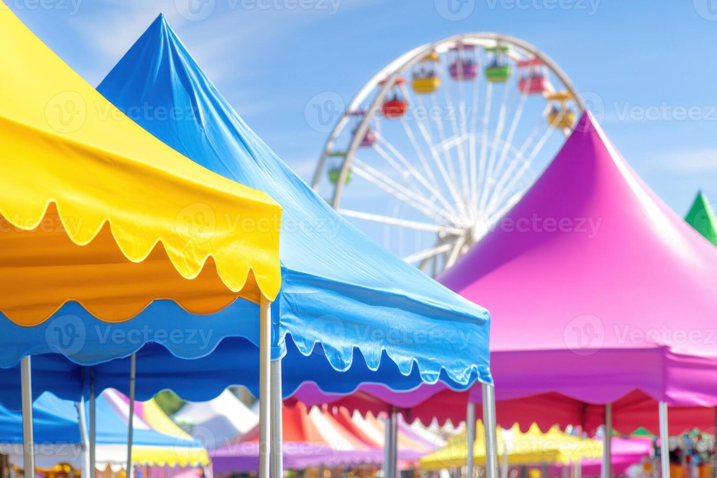 Vibrant carnival tents and lively attractions create a festive atmosphere in a colorful fairground during a sunny day photo