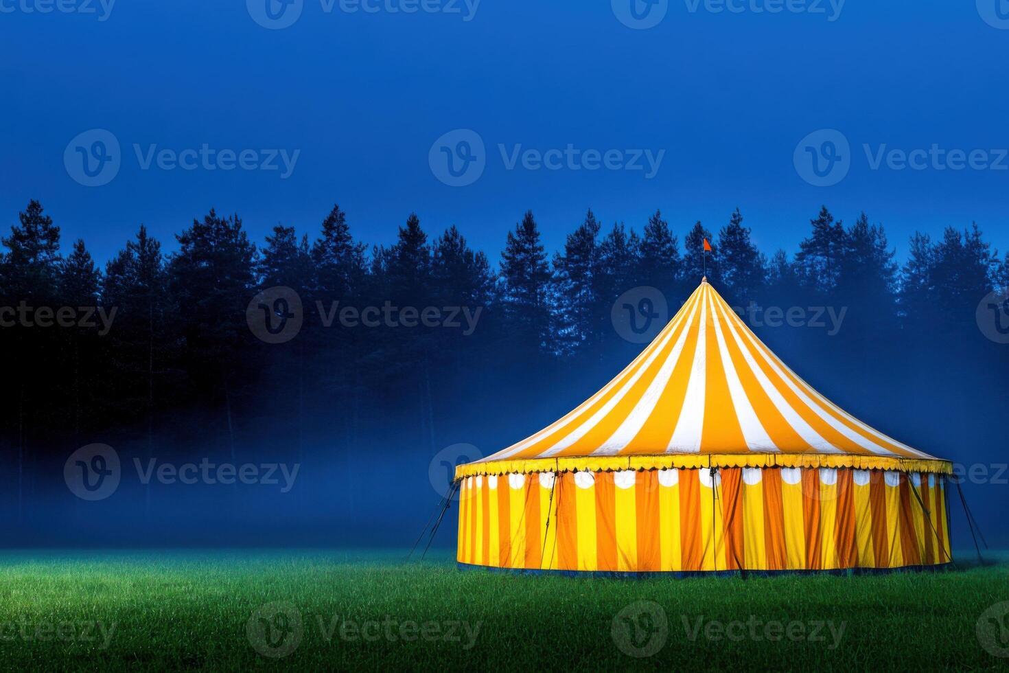 Mysterious abandoned carnival tent shrouded in fog at night in a lonely field photo