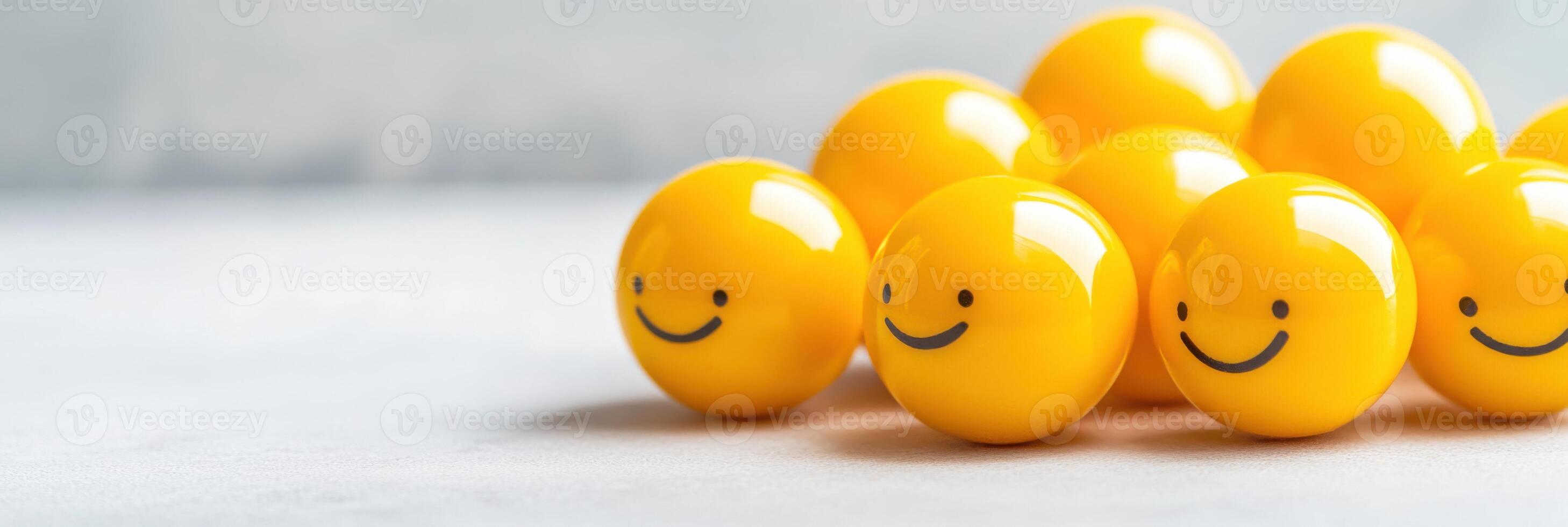 Creative arrangement of yellow smiley face balls creating a playful spherical shape under soft lighting in a minimalistic setting photo