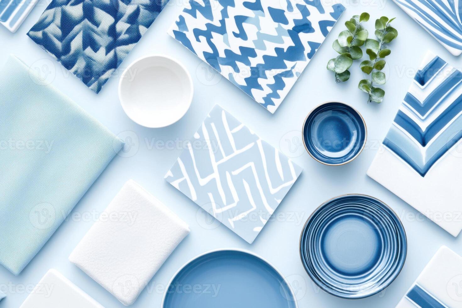 Meticulously arranged mood board showcasing interior design materials in various shades of blue with ceramic tiles, fabric swatches, and decorative accents against a pastel background photo