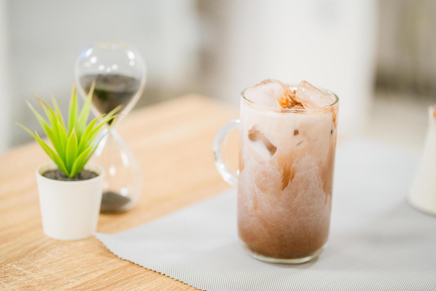 Iced cocoa in clear glass on table. photo
