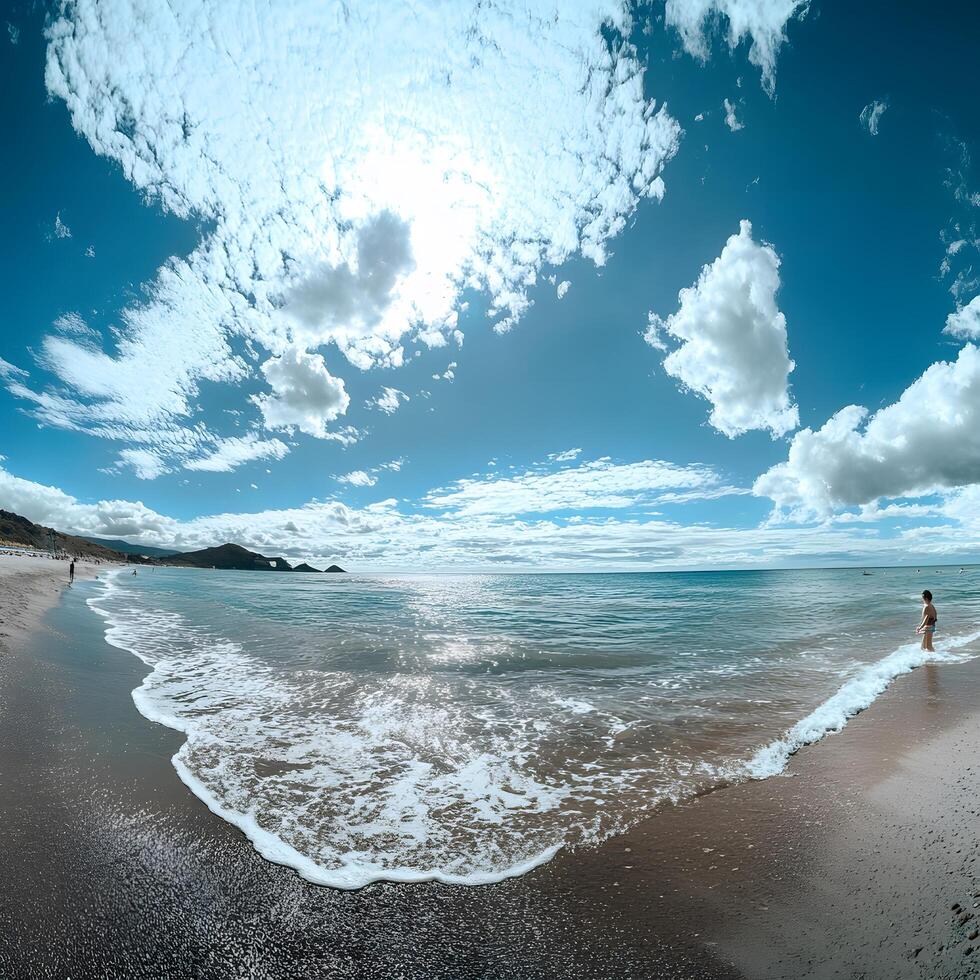 A person walking on the beach near the ocean photo