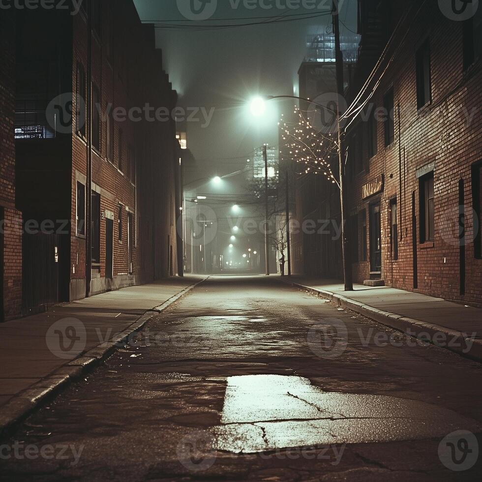 A foggy night alley with wet pavement reflecting the glow of distant streetlights. Tall buildings form a narrow passage, while scattered cables and poles add to the urban scenes depth photo