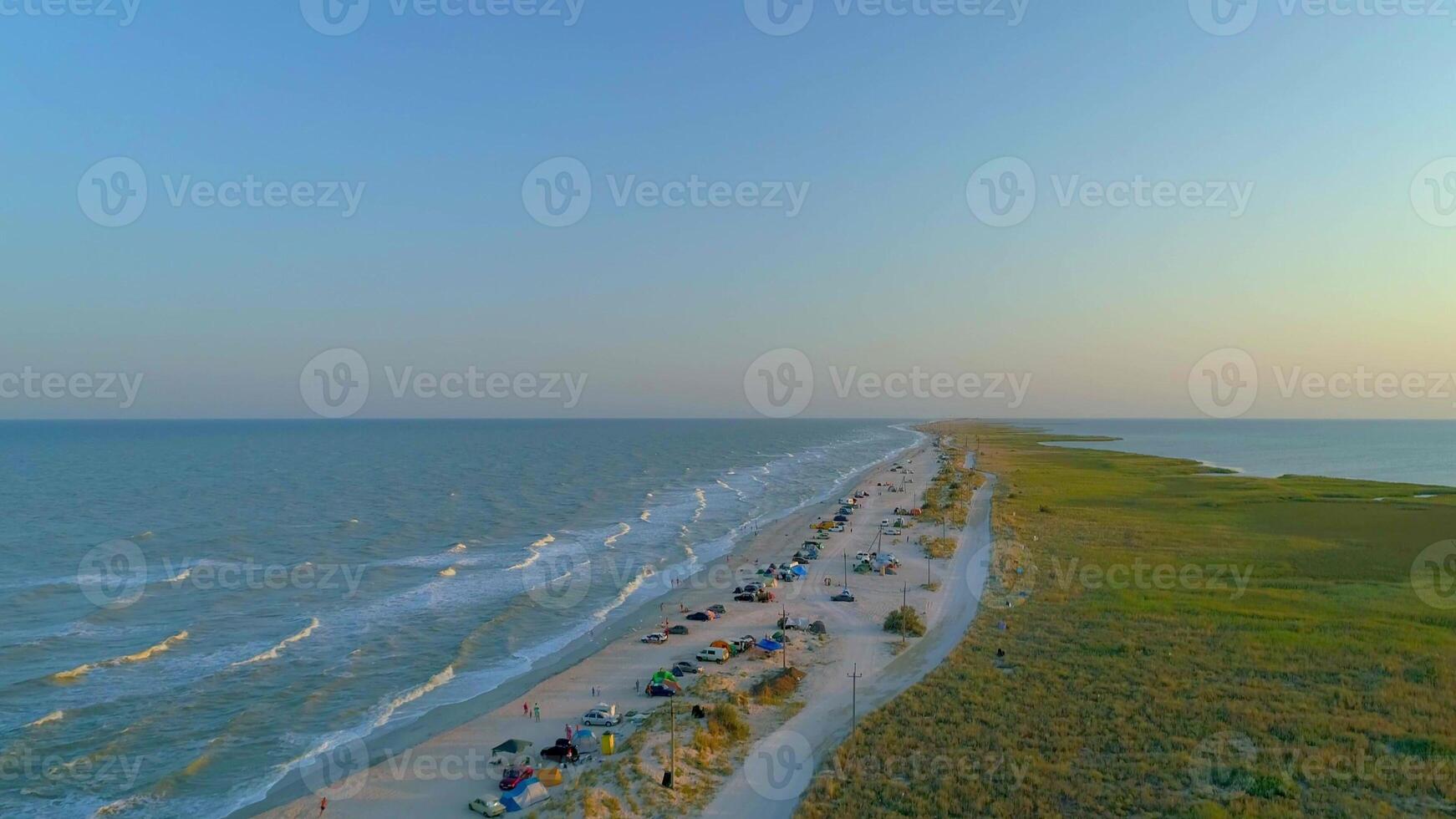 Sea sand spit with people camping, rest and relax on beach, view from above photo