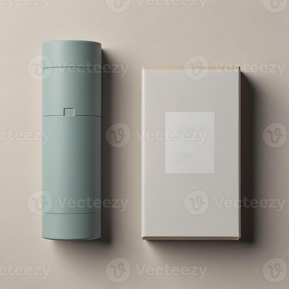 A cylinder in light blue is next to a rectangular box in white. Both are open on a beige surface. photo