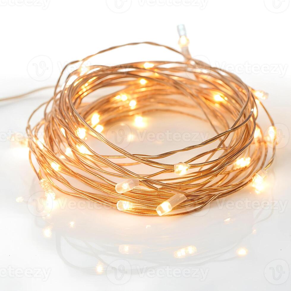 A coiled string of warm, glowing fairy lights., isolated on a white background photo