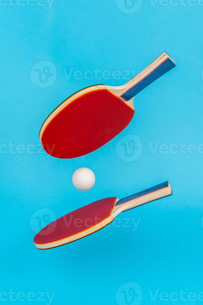 Red ping pong racket on a blue background photo