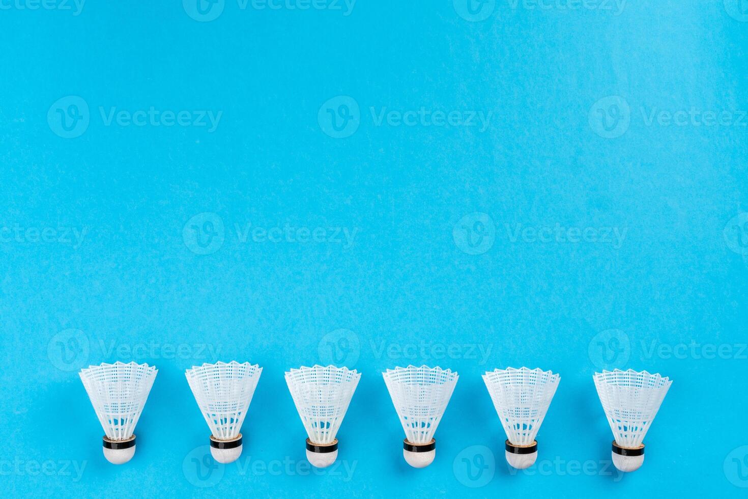Arrangement of shuttlecocks on a blue background photo